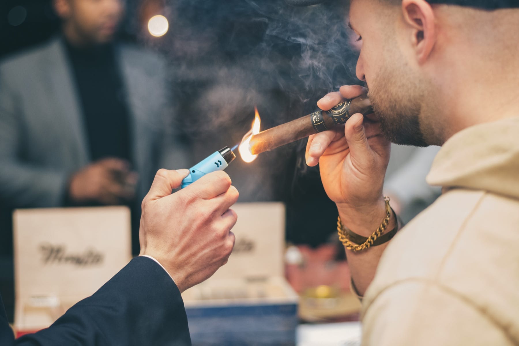A Mayfin cigar being lit at a Smoke and Sip event
