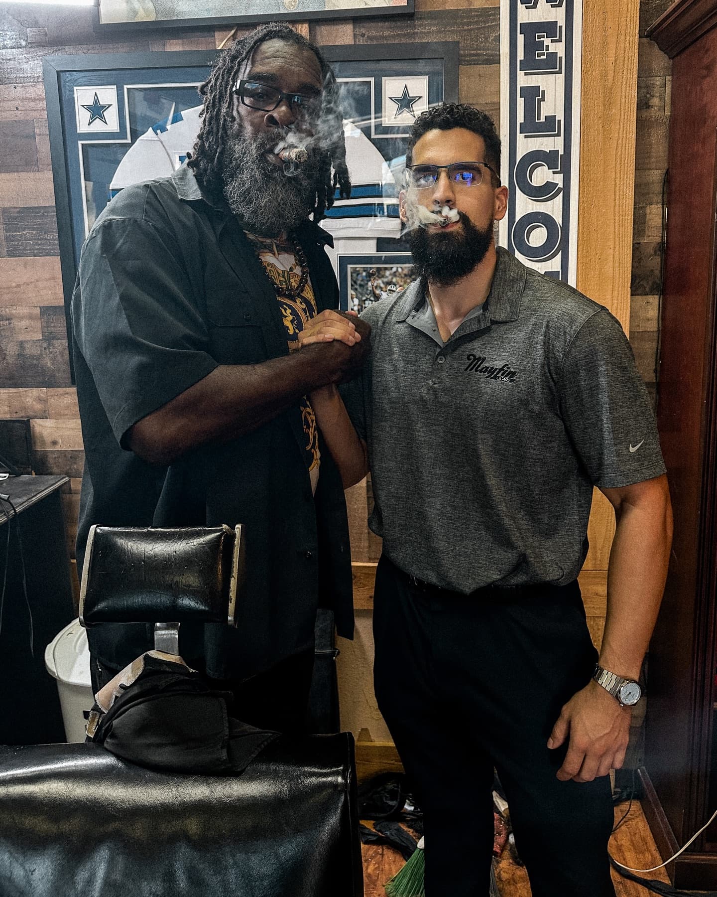 A Mayfin team member sharing a cigar with a lounge owner